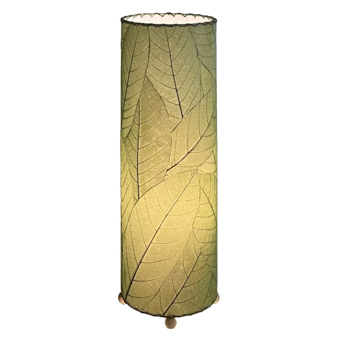 Crafted by the artisans of Eangee Home Design, the 24 Inch Cocoa Leaf Cylinder Table Lamp in green against a clean backdrop, featuring fossilized cocoa leaf shade, fair trade, eco friendly, sustainably sourced, handcrafted.