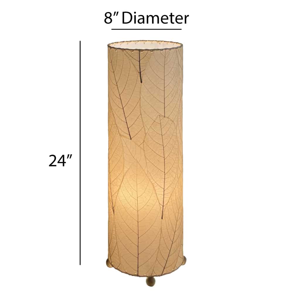 Crafted by the artisans of Eangee Home Design, the 24 Inch Cocoa Leaf Cylinder Table Lamp in natural against a clean backdrop, featuring fossilized cocoa leaf shade, fair trade, eco friendly, sustainably sourced, handcrafted.