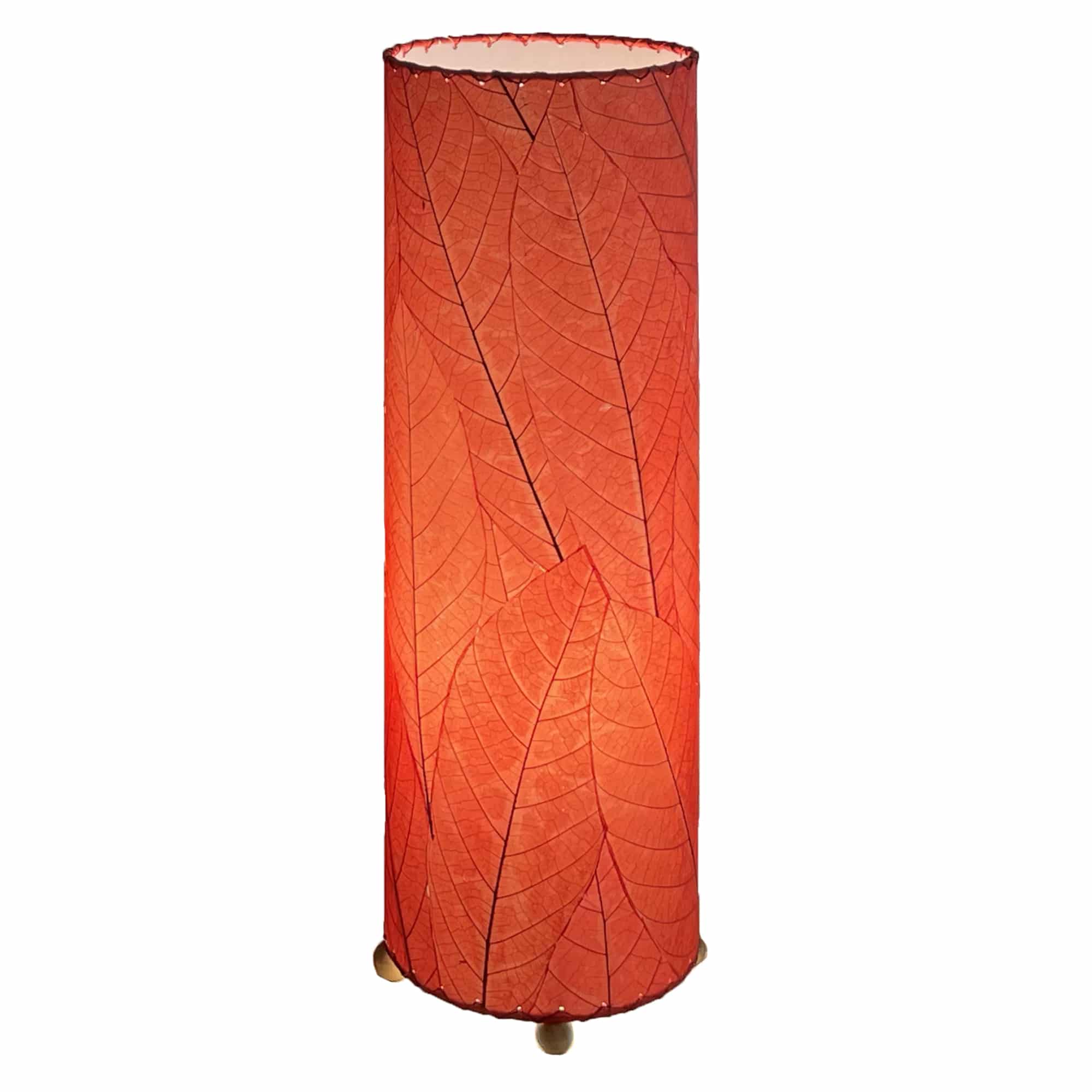 Crafted by the artisans of Eangee Home Design, the 24 Inch Cocoa Leaf Cylinder Table Lamp in red against a clean backdrop, featuring fossilized cocoa leaf shade, fair trade, eco friendly, sustainably sourced, handcrafted.