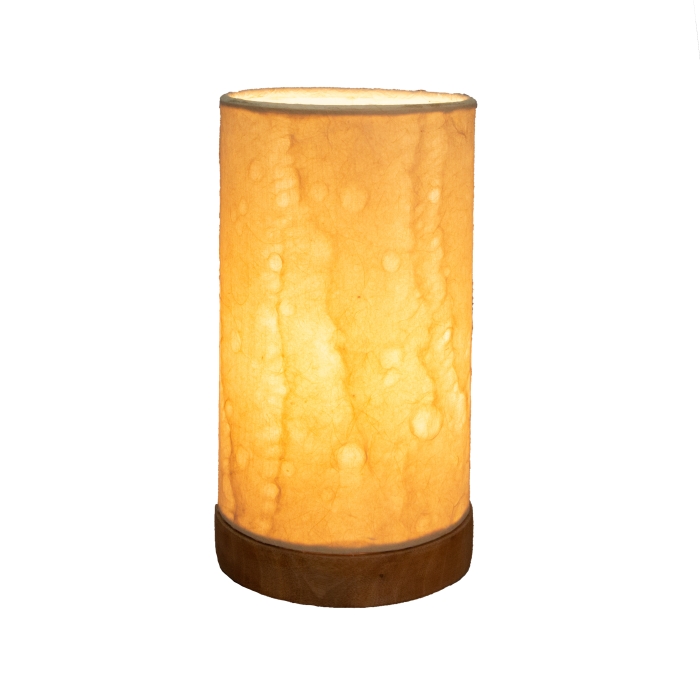 Crafted by the artisans of Eangee Home Design, the Mini Paper Cylinder Table Lamp Wave in natural against a clean backdrop, featuring reclaimed mango wood base, recycled paper shade, sustainably sourced, recycled materials.