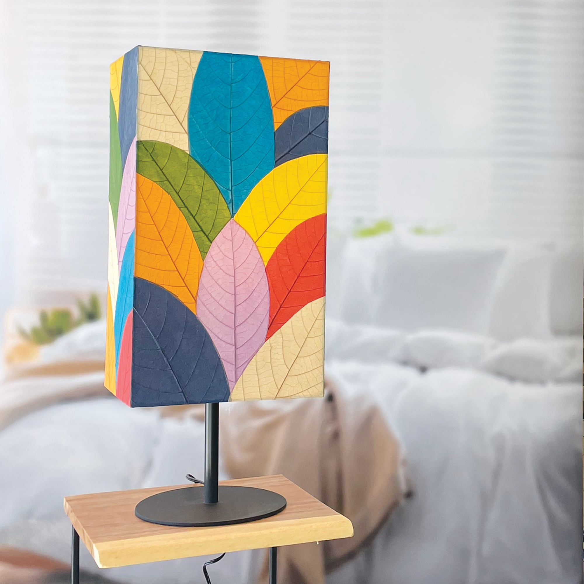In a modern interior with earth tones, crafted by the artisans of Eangee Home Design, the Sequoia Table Lamp in multi color stands gracefully, featuring fossilized cocoa leaf shade, fair trade, sustainably sourced, adding warmth and character to the space.