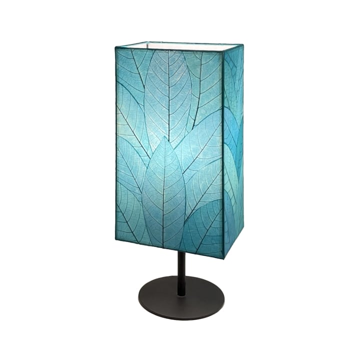 Crafted by the artisans of Eangee Home Design, the Sequoia Table Lamp in sea blue against a clean backdrop, featuring fossilized cocoa leaf shade, fair trade, sustainably sourced.