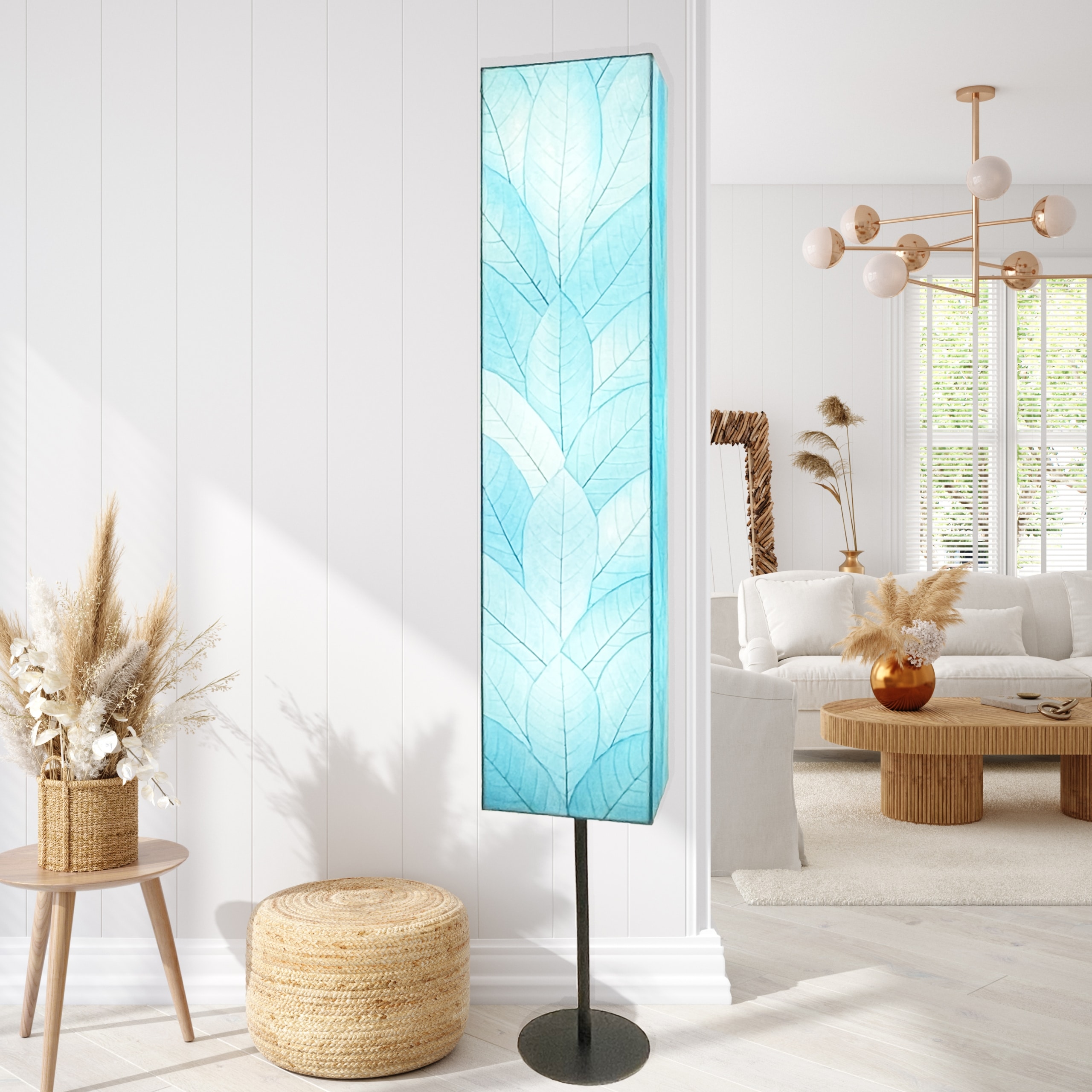 Crafted by the artisans of Eangee Home Design, the Sequoia Giant Floor Lamp in sea blue against a clean backdrop, featuring fossilized cocoa leaf shade, fair trade, handcrafted.