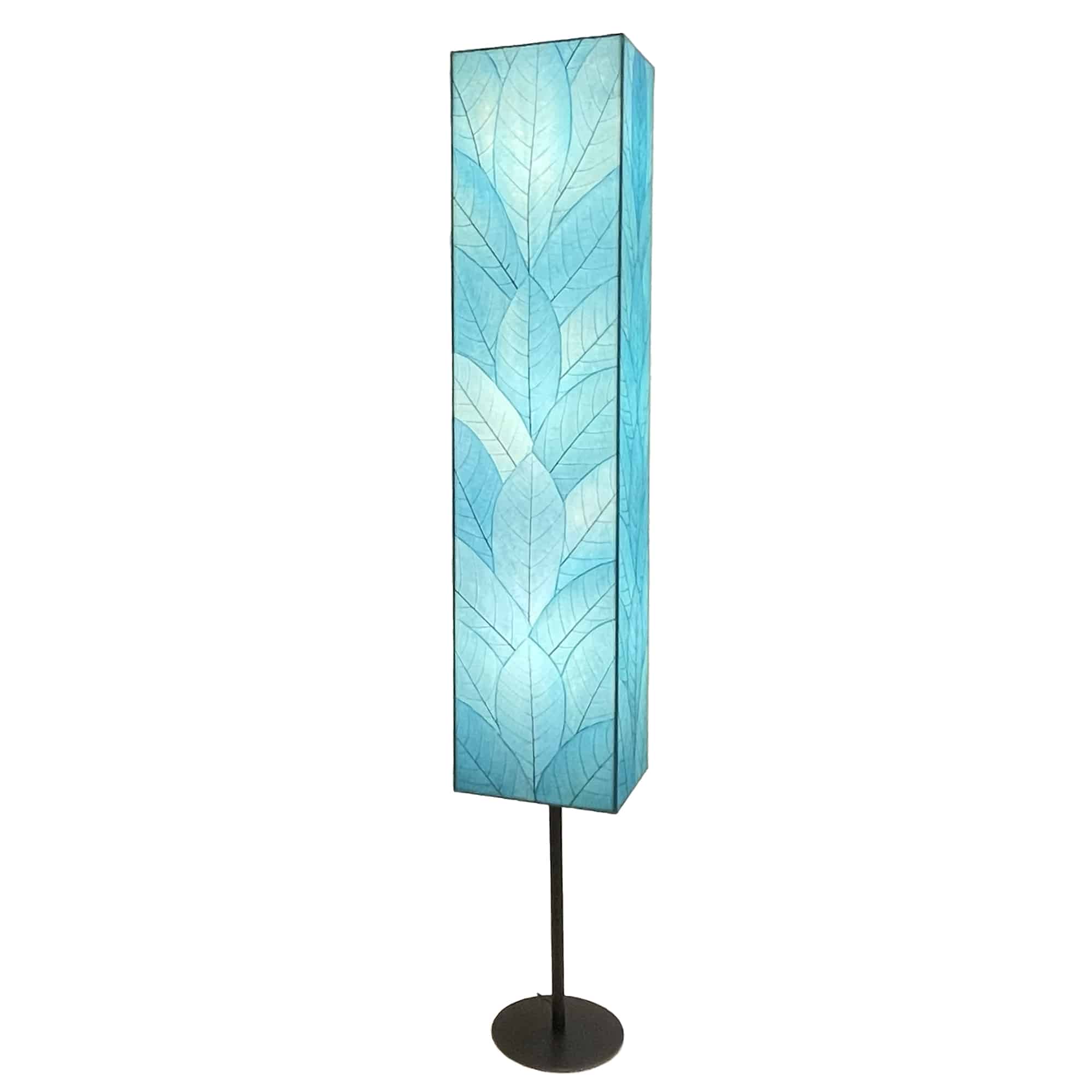 Crafted by the artisans of Eangee Home Design, the Sequoia Giant Floor Lamp in sea blue against a clean backdrop, featuring fossilized cocoa leaf shade, fair trade, handcrafted.