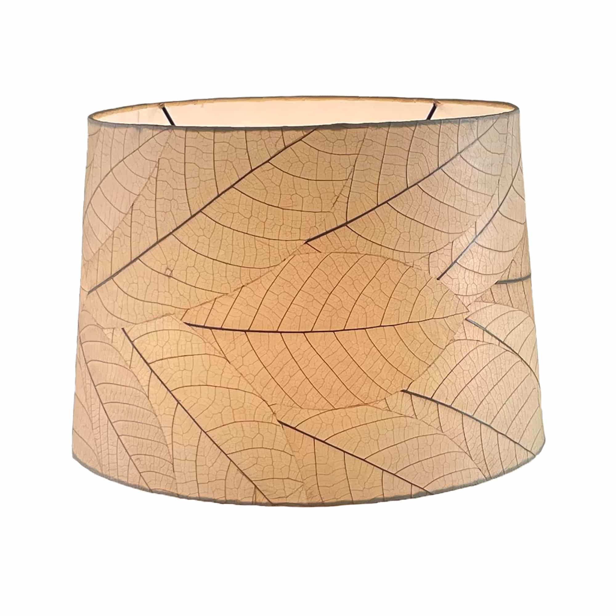 Crafted by the artisans of Eangee Home Design, the 16 Inch Tapered Drum Shade in natural against a clean backdrop, featuring fossilized cocoa leaf shade, wrought iron frame, fair trade, sustainably sourced, handcrafted.