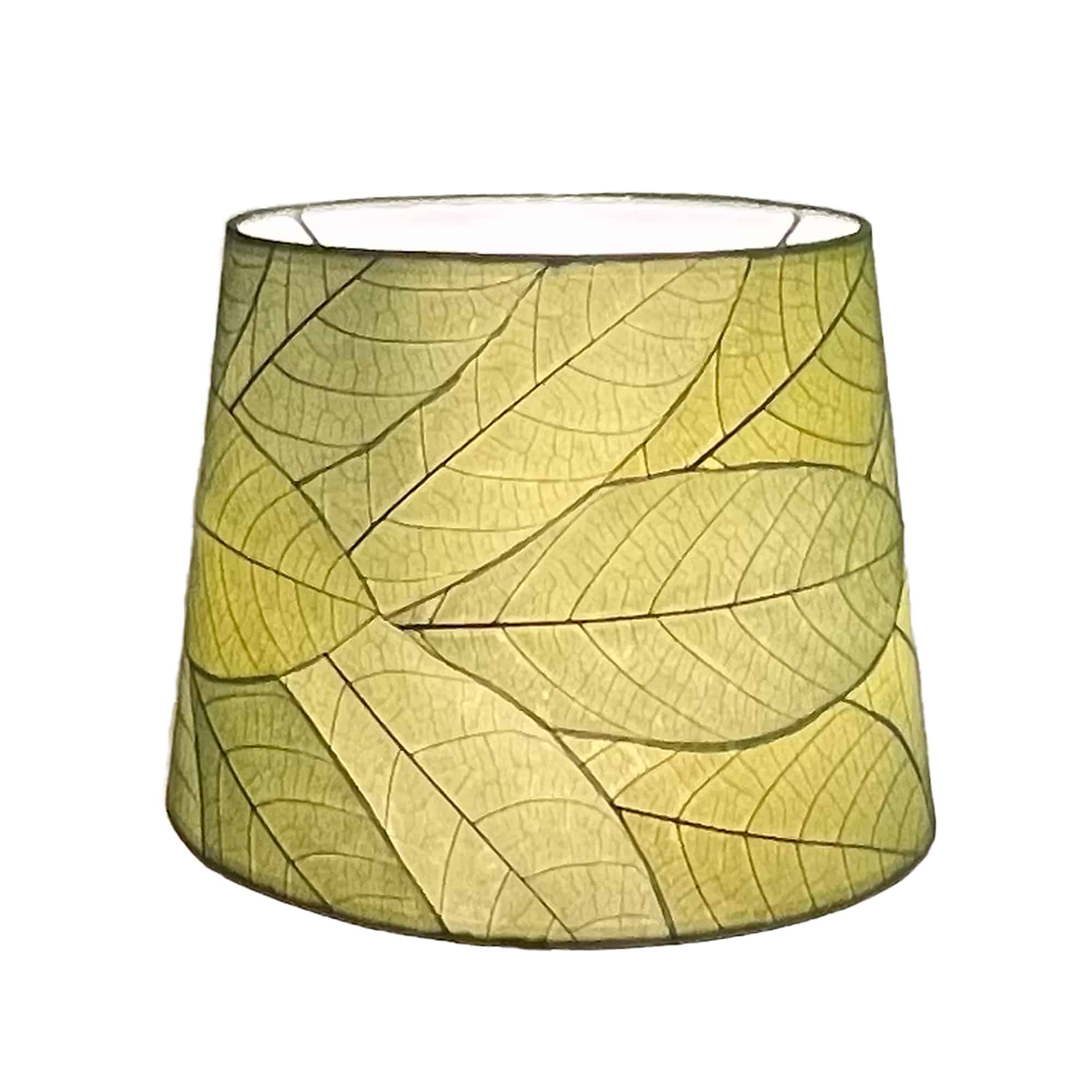 Crafted by the artisans of Eangee Home Design, the 12 Inch Tapered Drum Shade in green against a clean backdrop, featuring fossilized cocoa leaf shade, fair trade.