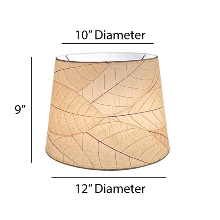 Crafted by the artisans of Eangee Home Design, the 12 Inch Tapered Drum Shade in natural against a clean backdrop, featuring fossilized cocoa leaf shade, fair trade.