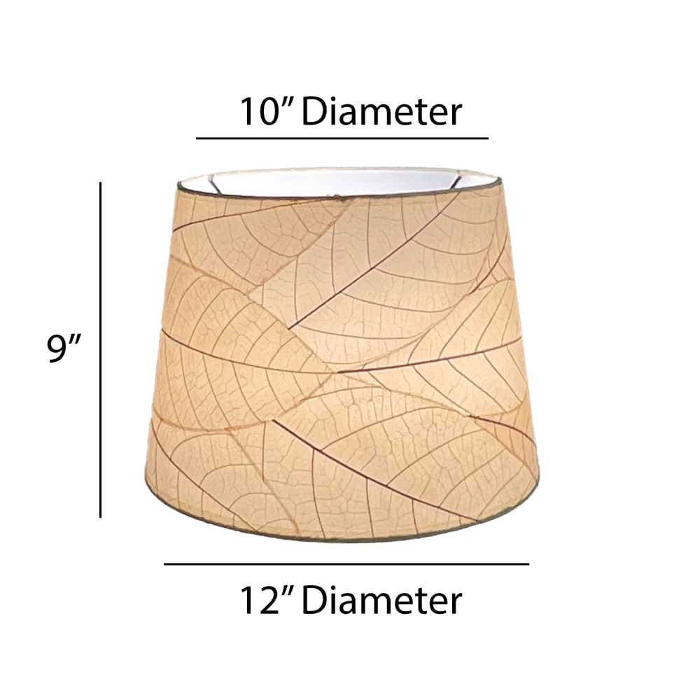 Crafted by the artisans of Eangee Home Design, the 12 Inch Tapered Drum Shade in natural against a clean backdrop, featuring fossilized cocoa leaf shade, fair trade.