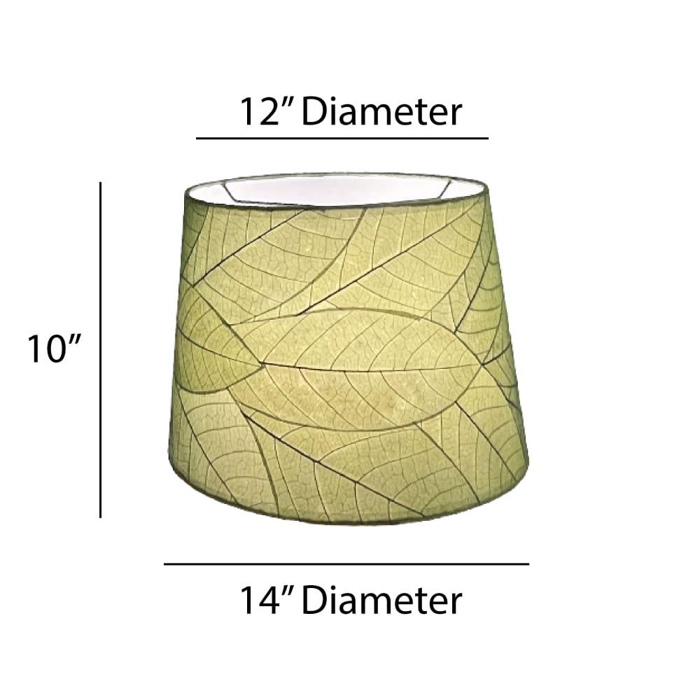 Crafted by the artisans of Eangee Home Design, the 14 Inch Tapered Drum Shade in green against a clean backdrop, featuring fossilized cocoa leaf shade, wrought iron frame, fair trade, eco friendly, sustainably sourced, handcrafted.