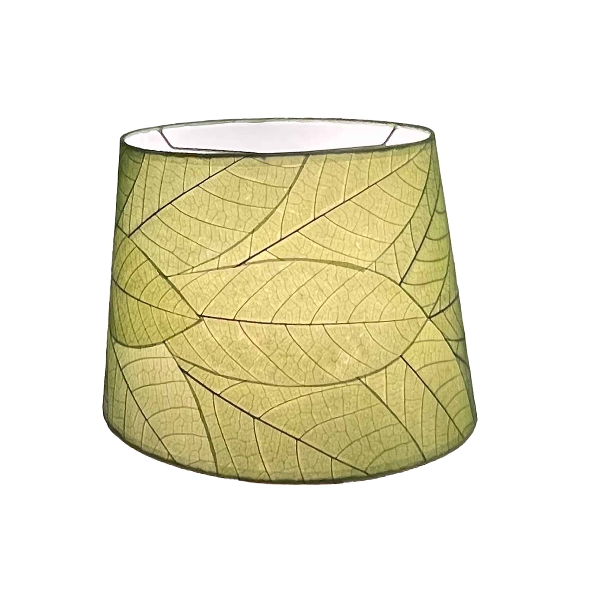 Crafted by the artisans of Eangee Home Design, the 14 Inch Tapered Drum Shade in green against a clean backdrop, featuring fossilized cocoa leaf shade, wrought iron frame, fair trade, eco friendly, sustainably sourced, handcrafted.