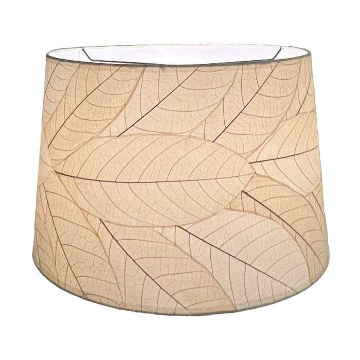 Crafted by the artisans of Eangee Home Design, the 18 Inch Tapered Drum Shade in natural against a clean backdrop, featuring fossilized cocoa leaf shade, wrought iron frame, eco friendly, sustainably sourced.