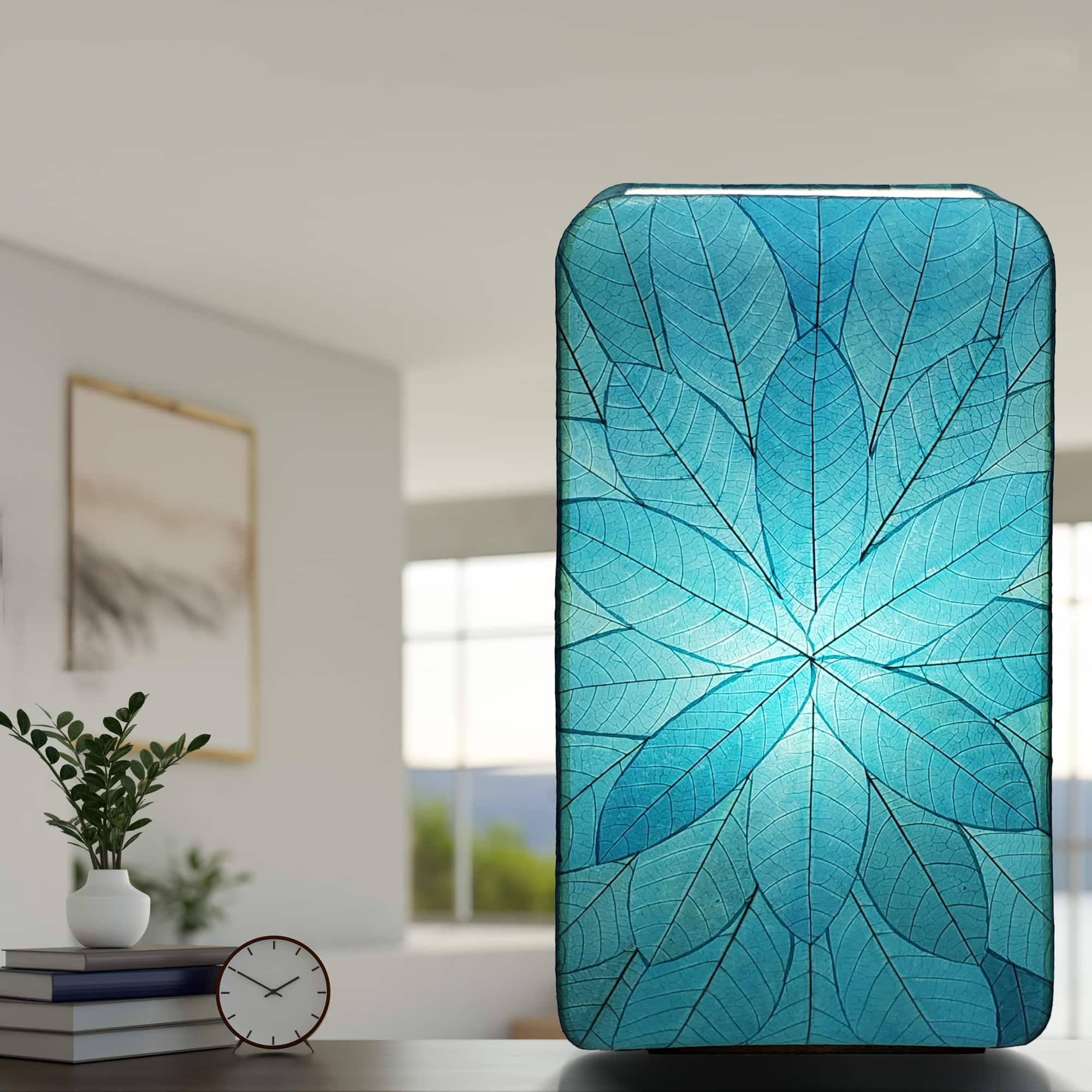 In a coastal inspired living room, crafted by the artisans of Eangee Home Design, the Sunburst Giant Floor Lamp in sea blue stands gracefully, featuring fossilized cocoa leaf shade, fair trade, handcrafted, adding warmth and character to the space.
