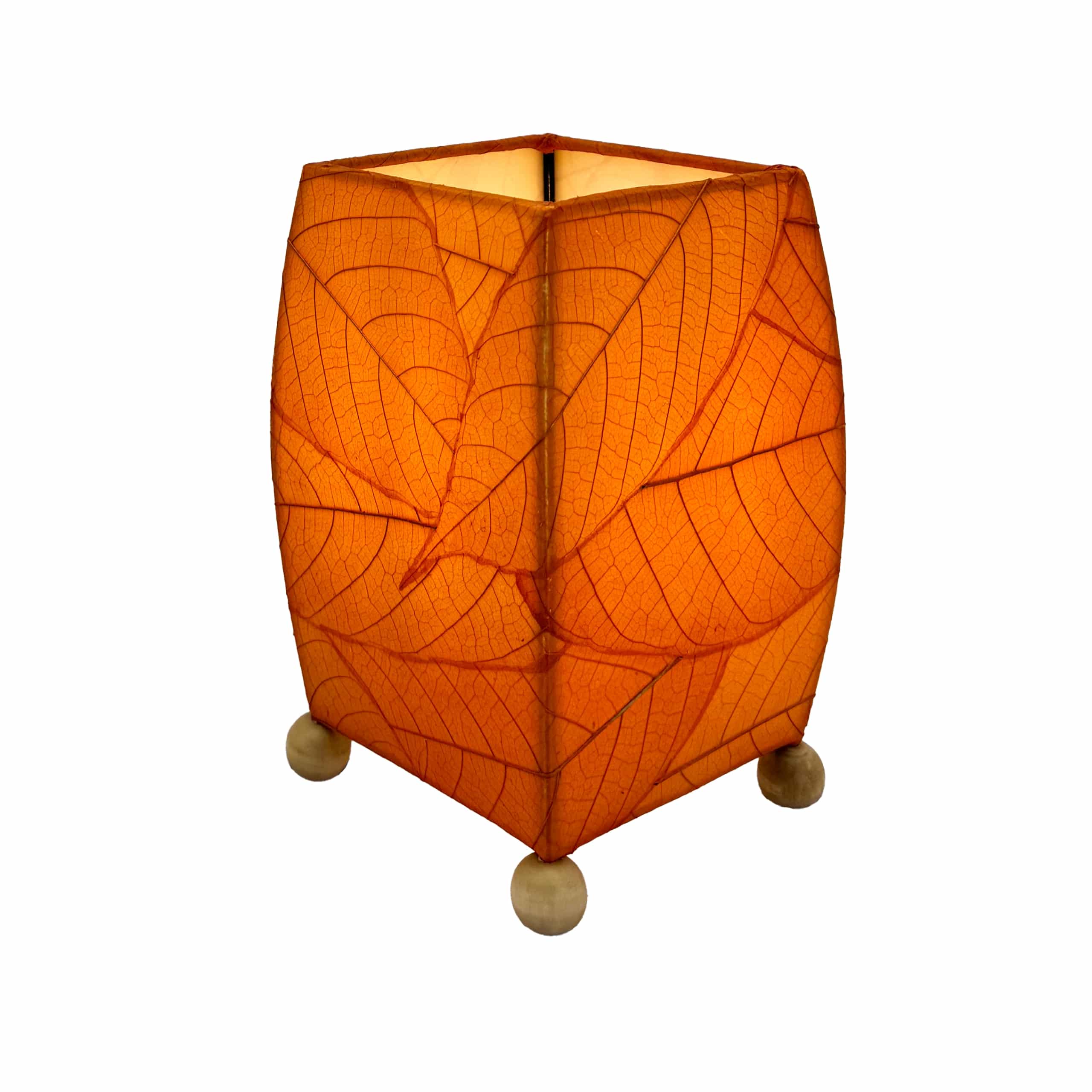 Crafted by the artisans of Eangee Home Design, the Mini Square Cocoa Leaf Table Lamp in orange against a clean backdrop, featuring fossilized cocoa leaf shade, wrought iron frame, fair trade, eco friendly, sustainably sourced, handcrafted.