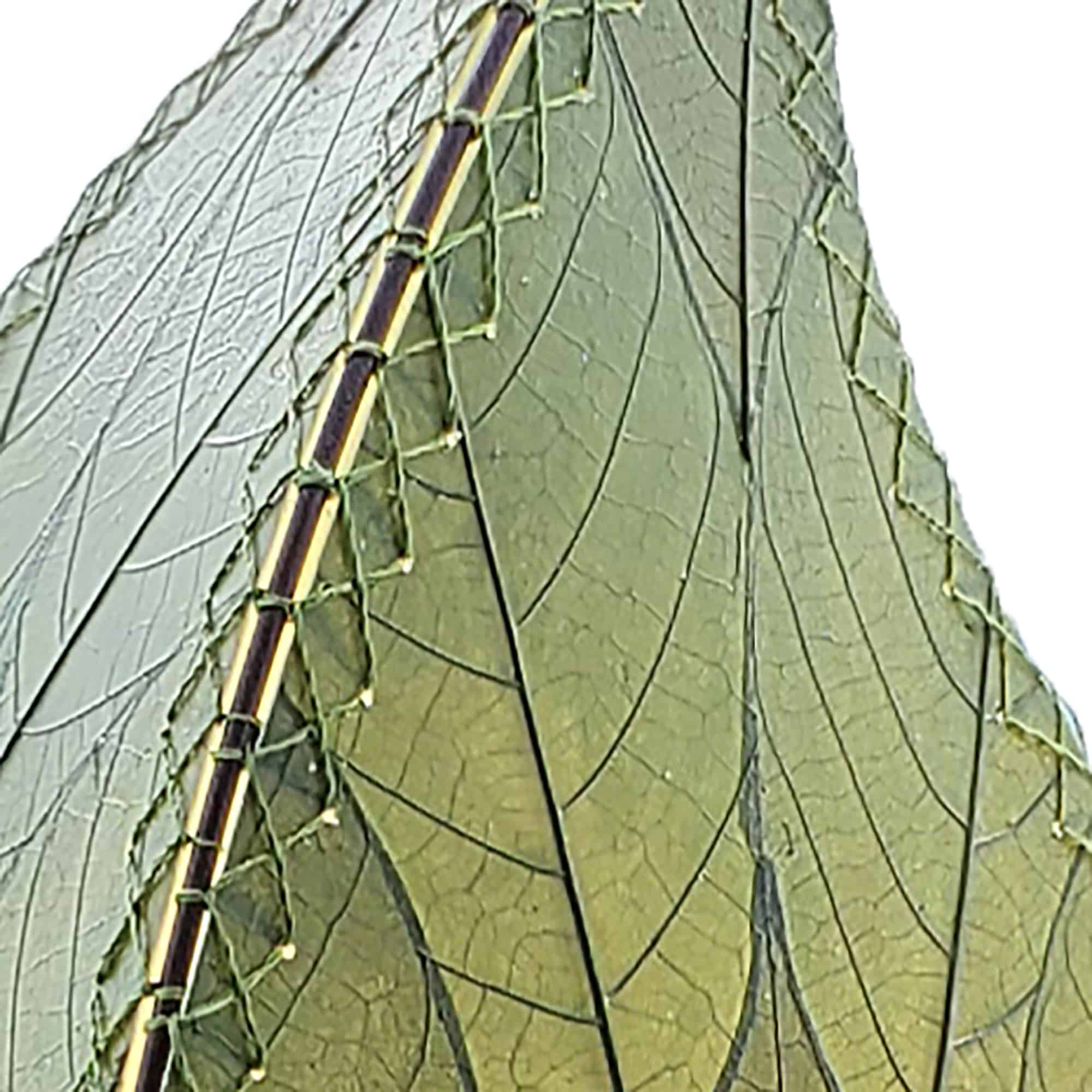 In a minimalist loft with natural textures, crafted by the artisans of Eangee Home Design, the 24 Inch Leaflet Lamp in green stands gracefully, featuring fossilized cocoa leaf shade, abaca rope accents, wrought iron frame, handcrafted, adding warmth and character to the space.