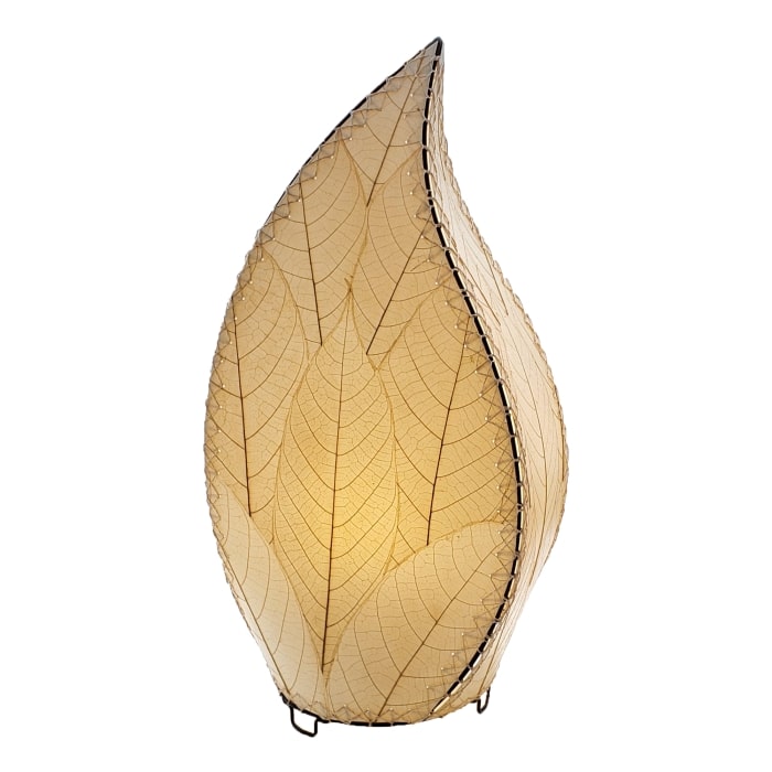 In a coastal inspired living room, crafted by the artisans of Eangee Home Design, the 24 Inch Leaflet Lamp in natural stands gracefully, featuring fossilized cocoa leaf shade, abaca rope accents, wrought iron frame, handcrafted, adding warmth and character to the space.