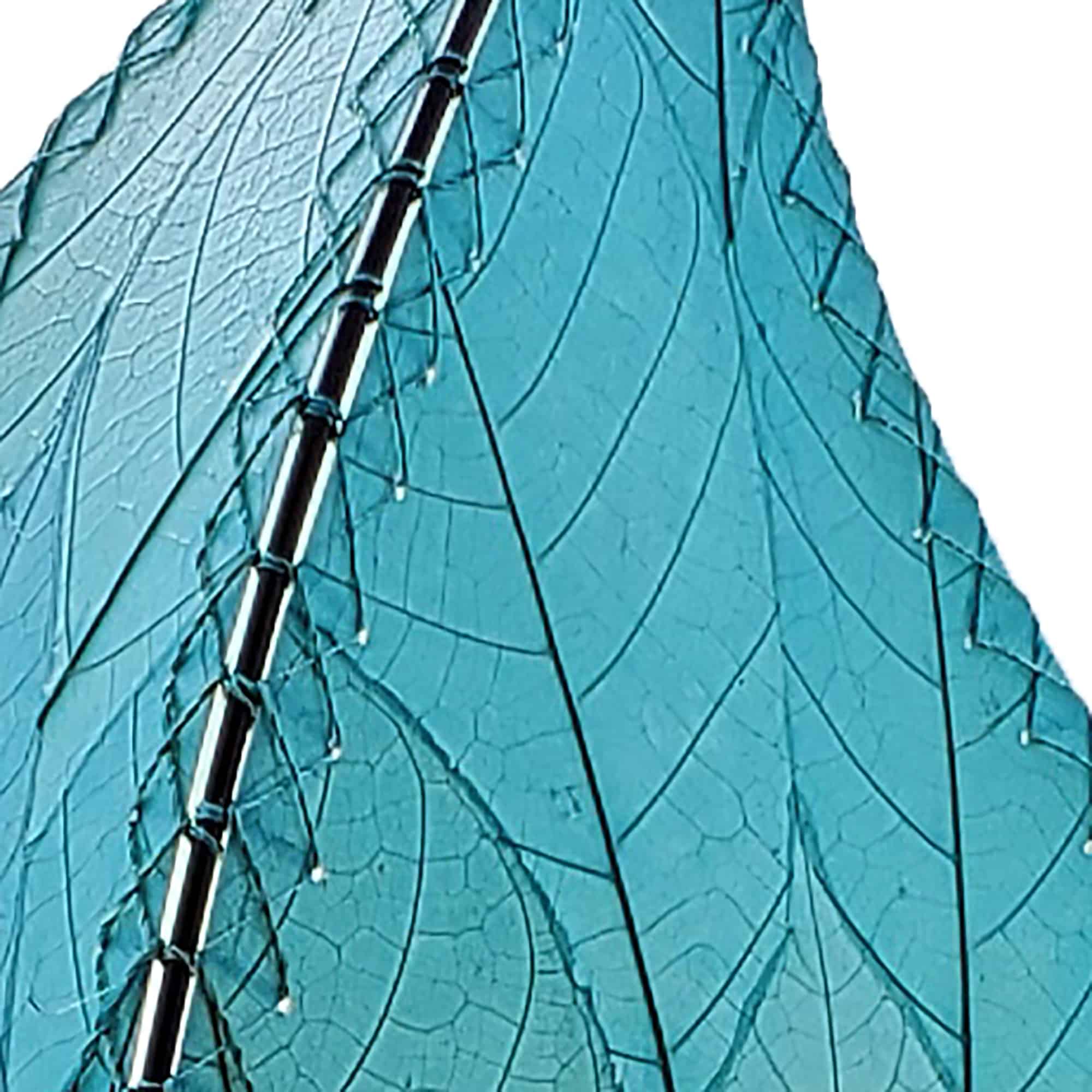 In a quiet bedside corner, crafted by the artisans of Eangee Home Design, the 24 Inch Leaflet Lamp in sea blue stands gracefully, featuring fossilized cocoa leaf shade, abaca rope accents, wrought iron frame, handcrafted, adding warmth and character to the space.