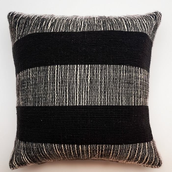 Black pillow cover crafted by the artisans of Dos Tierras called the Wool Pillow Cover Black featuring handwoven textile, handcrafted shown against a clean backdrop featuring shades of black.