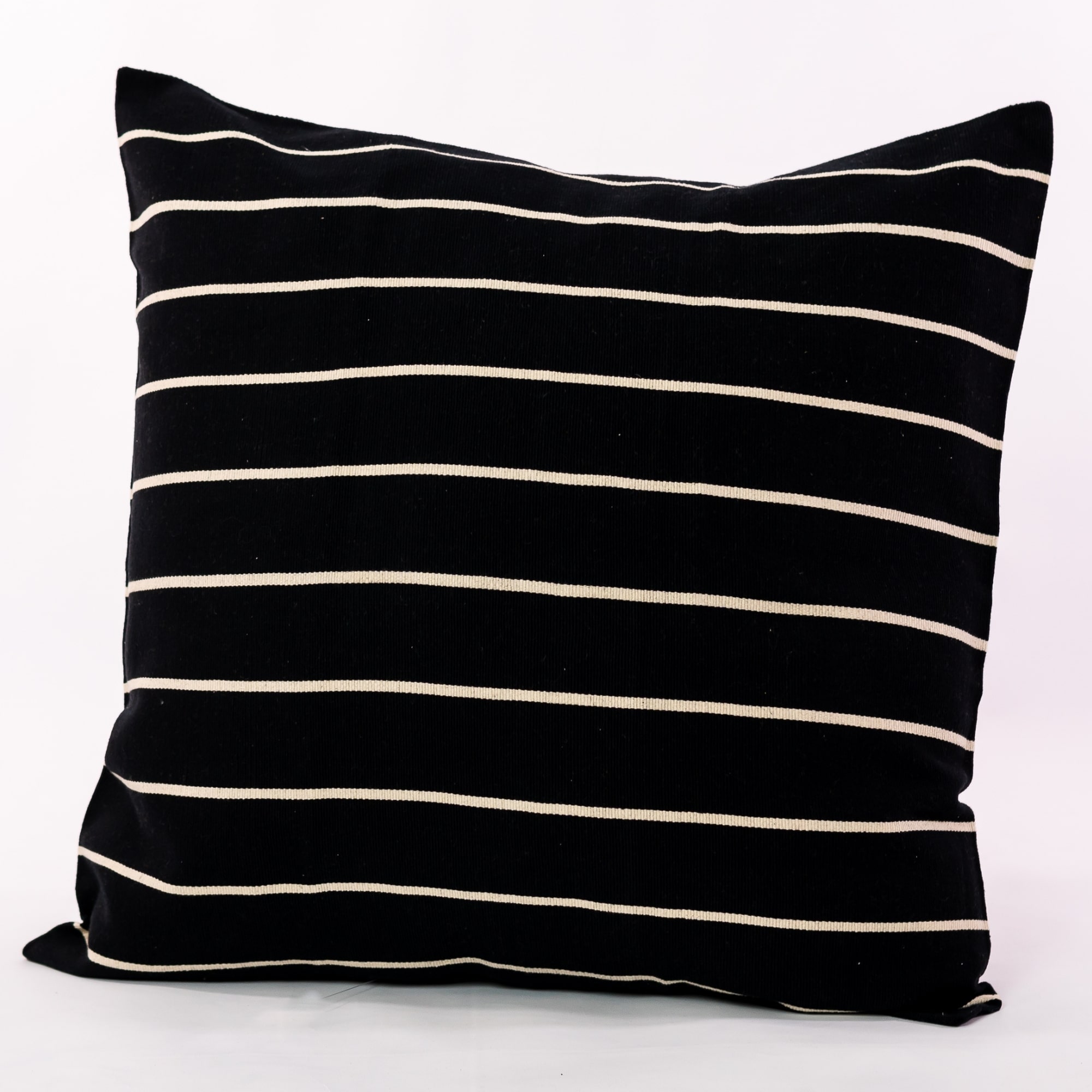 Black pillow cover crafted by the artisans of Magnolia Casual called the Rayas 2 Pillow Cover Black featuring handwoven textile, handcrafted shown against a clean backdrop featuring shades of black.