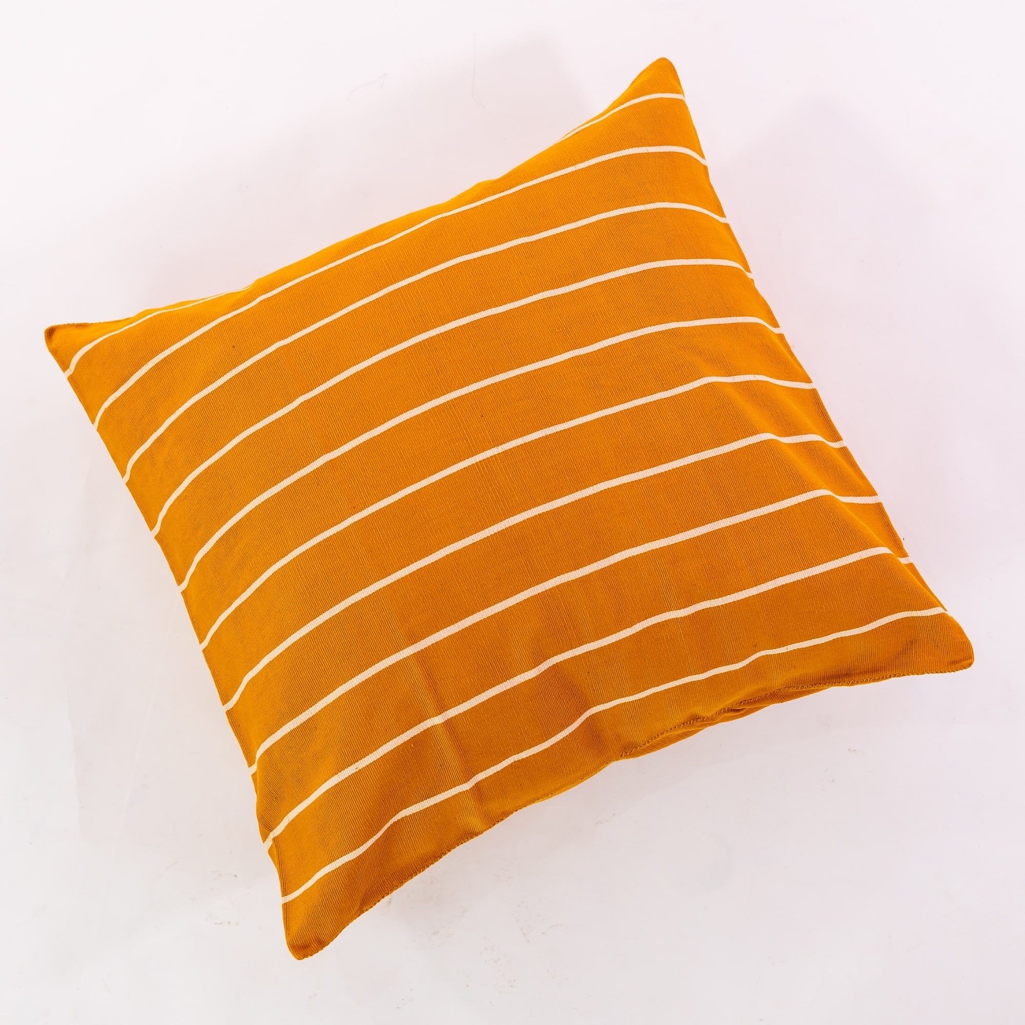 Gold pillow cover crafted by the artisans of Magnolia Casual called the Rayas 2 Pillow Cover Gold featuring handwoven textile, handcrafted shown against a clean backdrop featuring shades of gold.