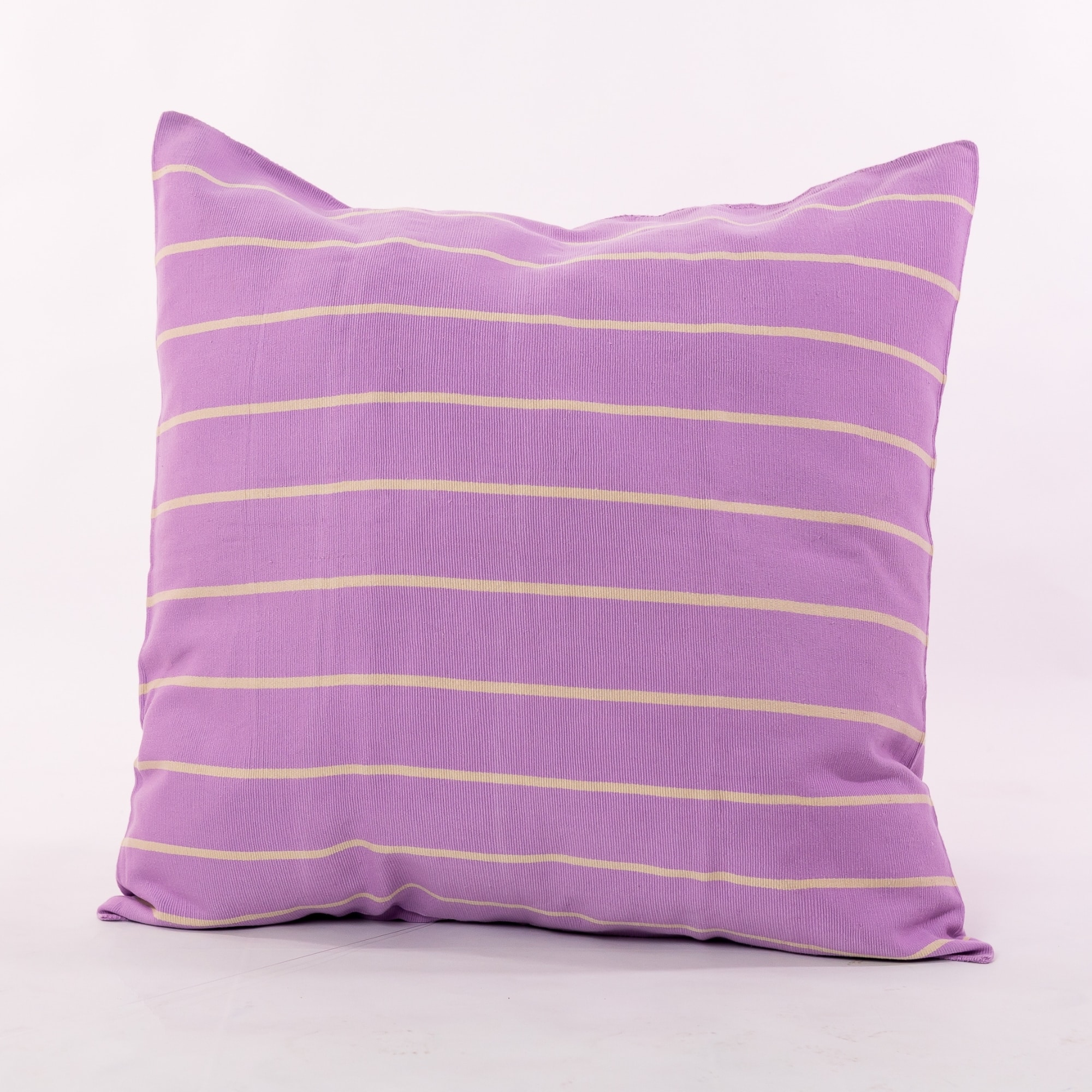 Purple pillow cover crafted by the artisans of Magnolia Casual called the Rayas 2 Pillow Cover Purple featuring handwoven textile, handcrafted shown against a clean backdrop featuring shades of purple.