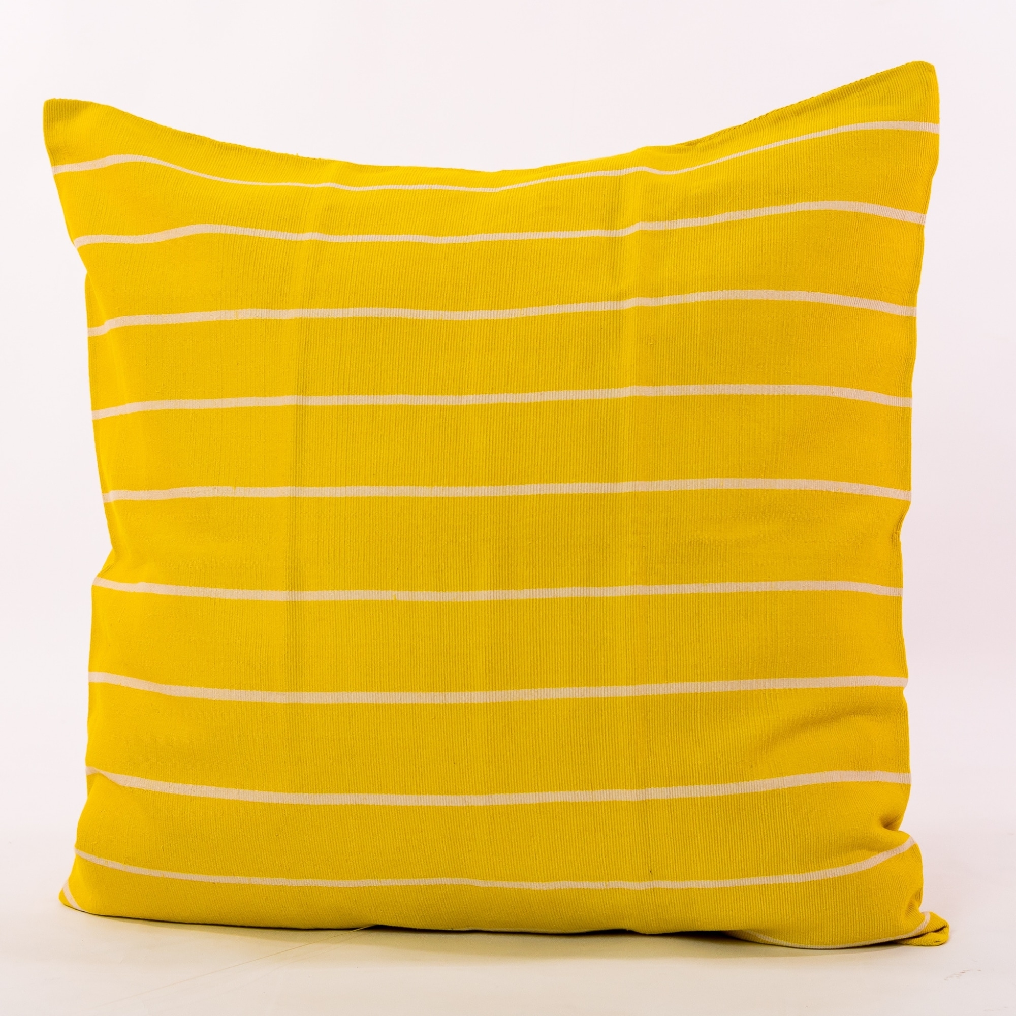 Yellow pillow cover crafted by the artisans of Magnolia Casual called the Rayas 2 Pillow Cover Yellow featuring handwoven textile, handcrafted shown against a clean backdrop featuring shades of yellow.