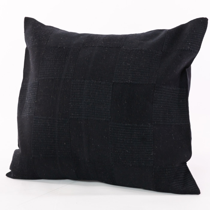 Black pillow cover crafted by the artisans of Dos Tierras called the Chess Pillow Cover Black featuring handwoven textile, handcrafted shown against a clean backdrop featuring shades of black.