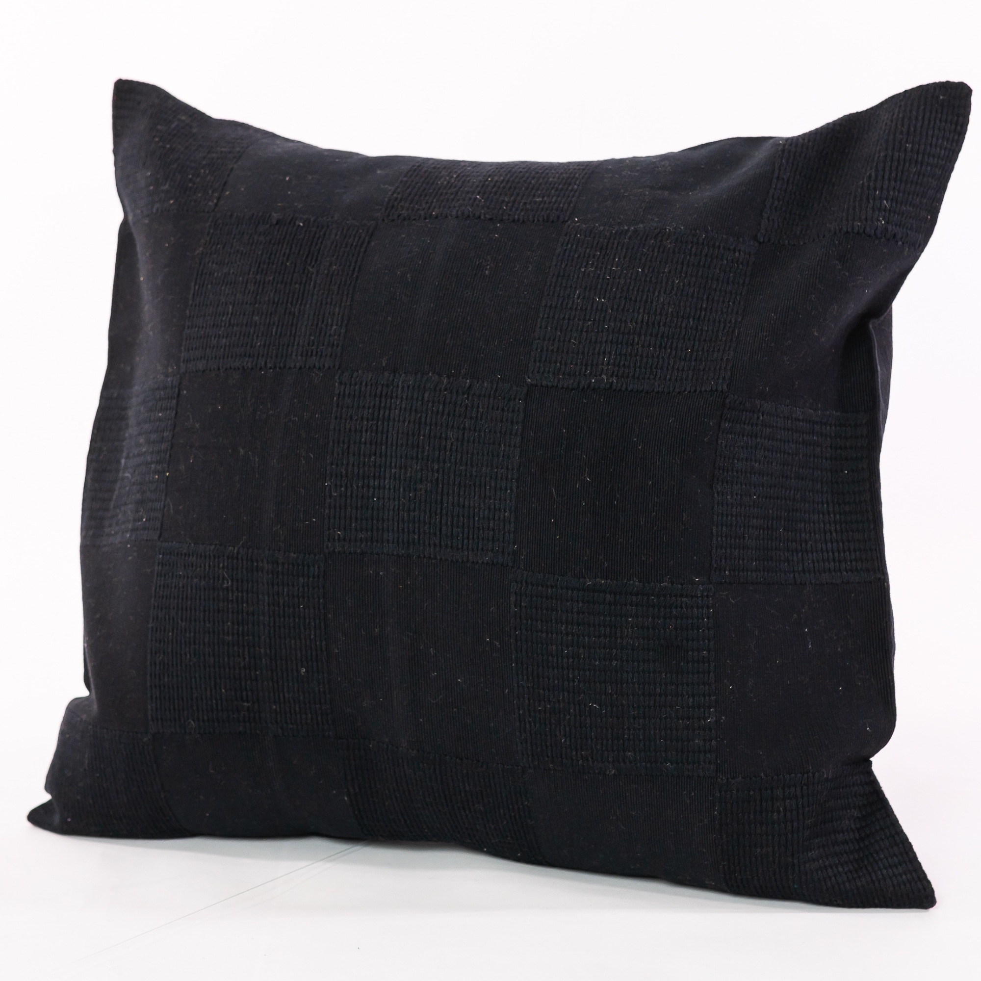 Black pillow cover crafted by the artisans of Dos Tierras called the Chess Pillow Cover Black featuring handwoven textile, handcrafted shown against a clean backdrop featuring shades of black.