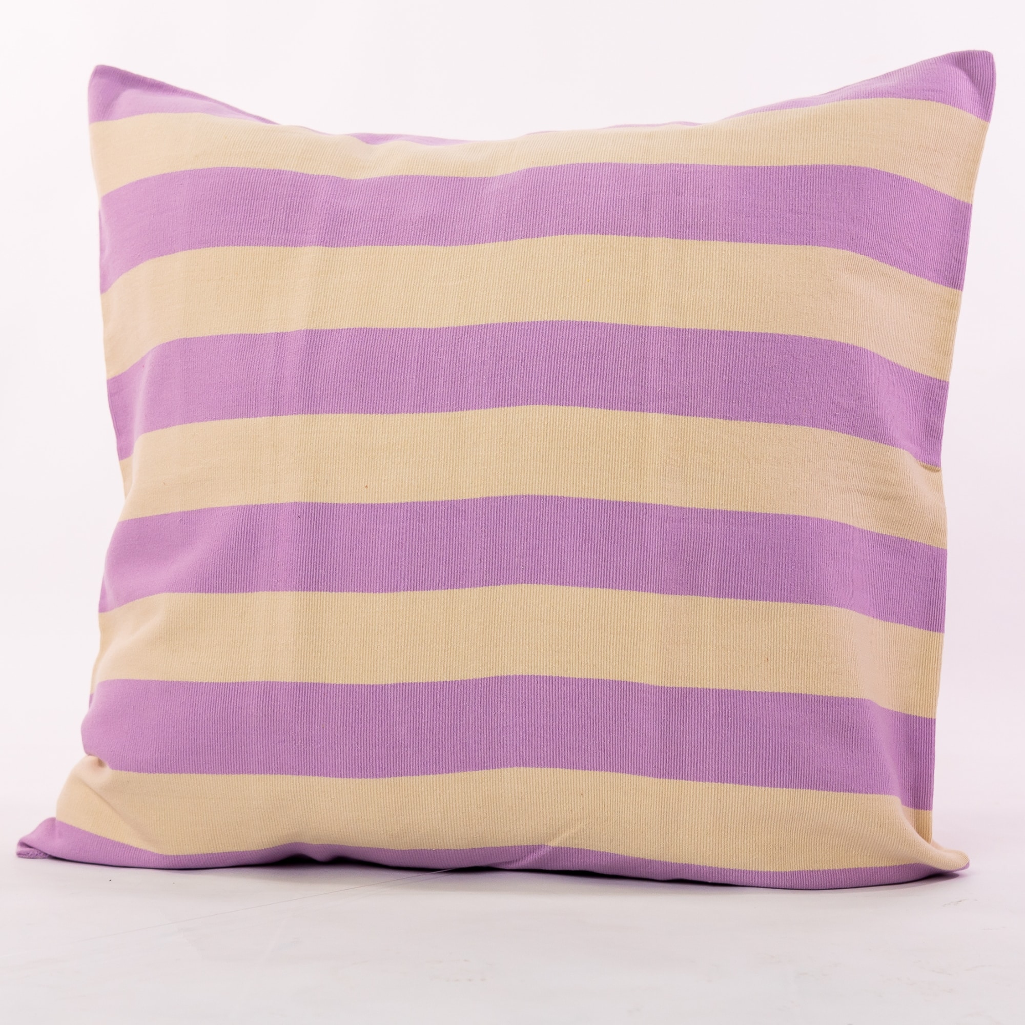 Purple pillow cover crafted by the artisans of Magnolia Casual called the Rayas Pillow Cover Purple featuring handwoven textile, handcrafted shown against a clean backdrop featuring shades of purple.