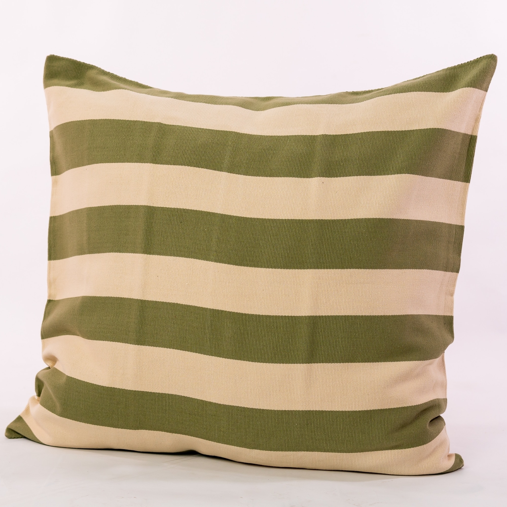 Green pillow cover crafted by the artisans of Magnolia Casual called the Rayas Pillow Cover Green featuring handwoven textile, handcrafted shown against a clean backdrop featuring shades of green.
