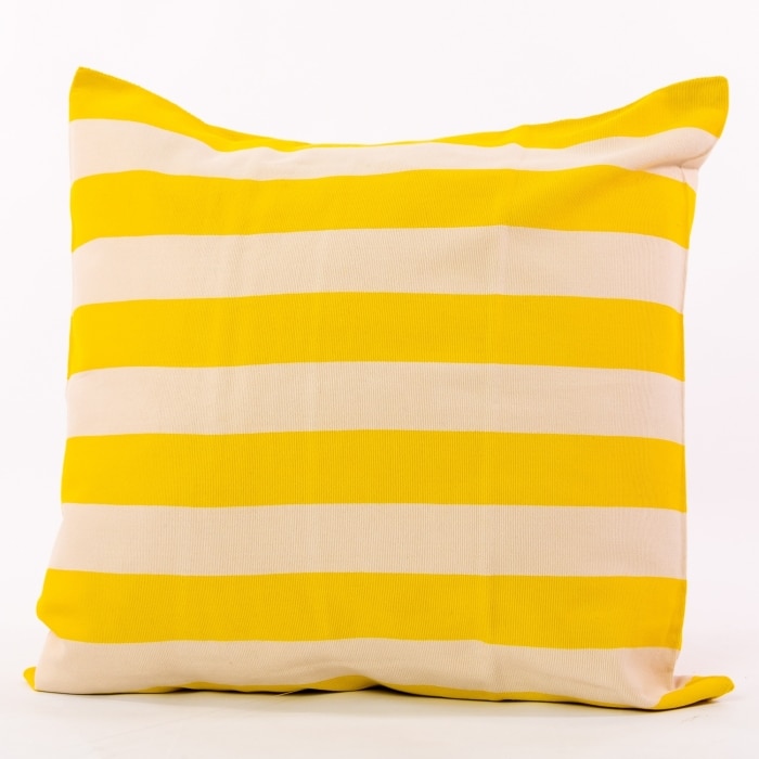 Yellow pillow cover crafted by the artisans of Magnolia Casual called the Rayas Pillow Cover Yellow featuring handwoven textile, handcrafted shown against a clean backdrop featuring shades of yellow.