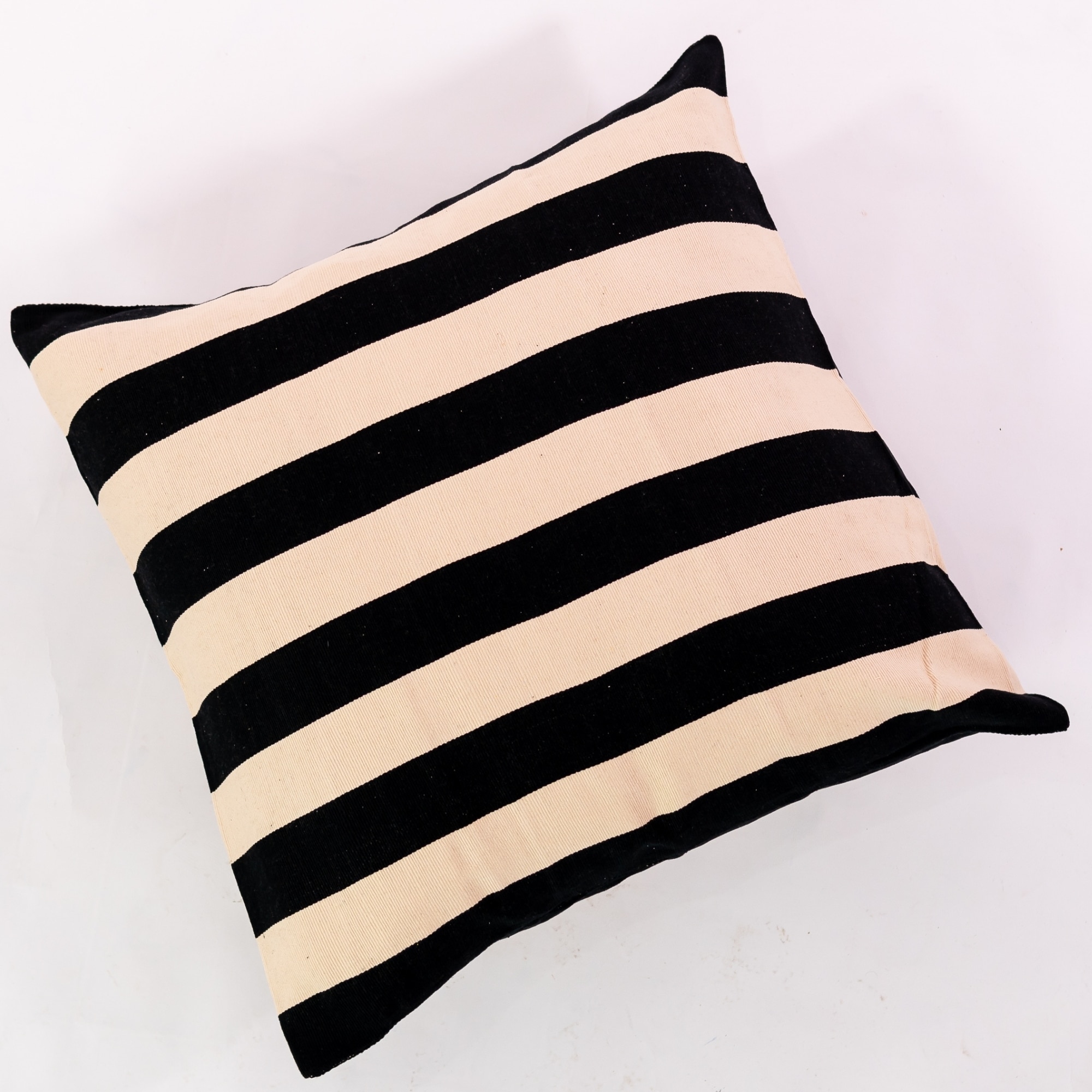 Black pillow cover crafted by the artisans of Magnolia Casual called the Rayas Pillow Cover Black featuring handwoven textile, handcrafted shown against a clean backdrop featuring shades of black.