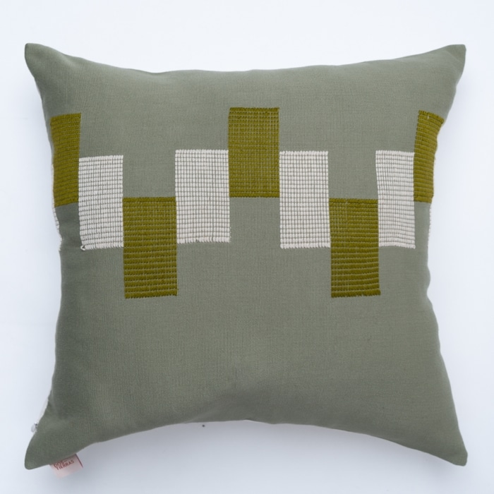 Green pillow cover crafted by the artisans of Dos Tierras called the Ve Pillow Cover Green featuring traditional backstrap loom weave, handwoven textile, handcrafted shown against a clean backdrop featuring shades of green.