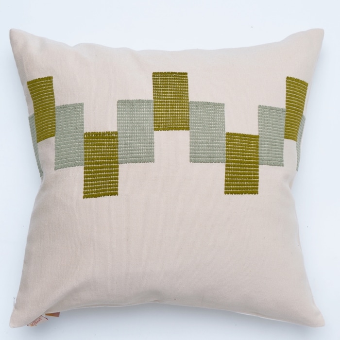 Green pillow cover crafted by the artisans of Dos Tierras called the Ve Pillow Cover Green Beige featuring traditional backstrap loom weave, handwoven textile, handcrafted shown against a clean backdrop featuring shades of green and beige.