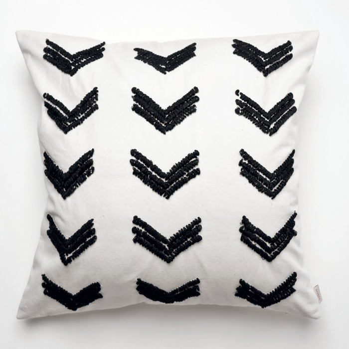 Black pillow cover crafted by the artisans of Dos Tierras called the Tuk Pillow Cover Black featuring quality outdoor fabric, handcrafted shown against a clean backdrop featuring shades of black.