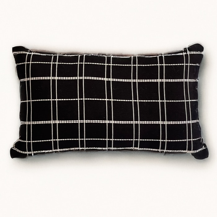 Black pillow cover crafted by the artisans of Dos Tierras called the Grid Lumbar Pillow Cover Black featuring handwoven textile, handcrafted shown against a clean backdrop featuring with a grid motif and shades of black.