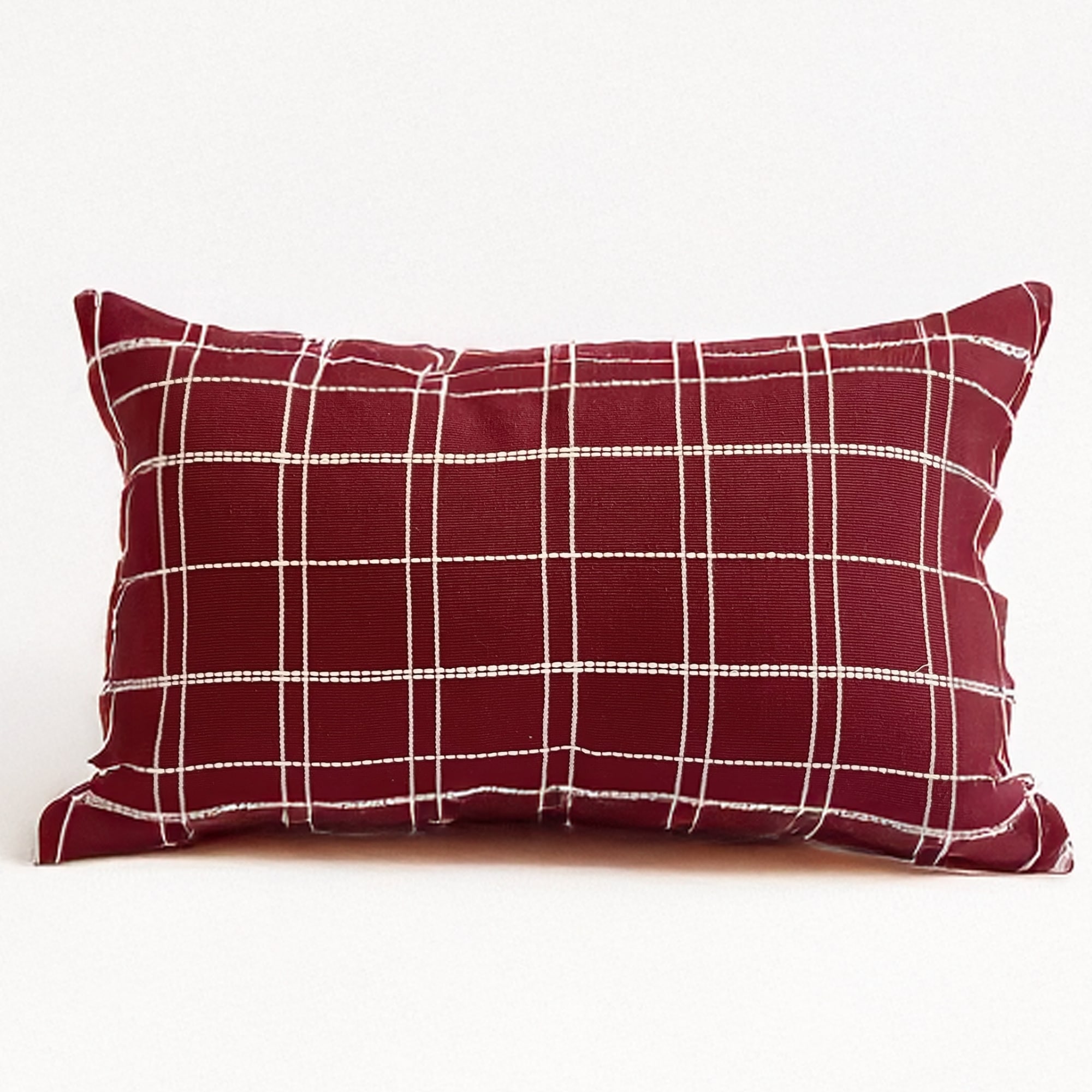 Burgundy pillow cover crafted by the artisans of Dos Tierras called the Grid Lumbar Pillow Cover Burgundy featuring handwoven textile, handcrafted shown against a clean backdrop featuring with a grid motif and shades of burgundy.
