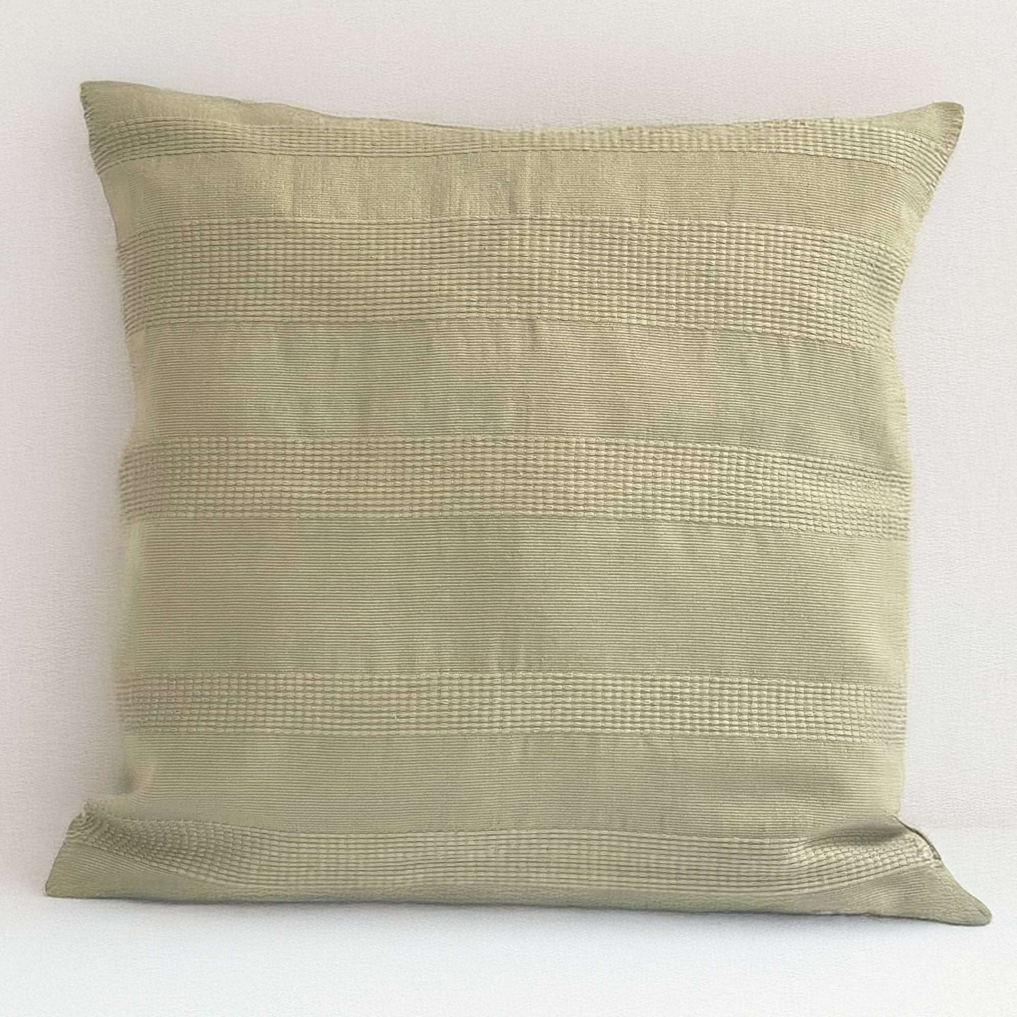 Green pillow cover crafted by the artisans of Magnolia Casual called the Lines Pillow Cover Green featuring handwoven textile, handcrafted shown against a clean backdrop featuring shades of green.
