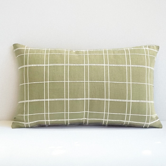 Green pillow cover crafted by the artisans of Dos Tierras called the Grid Lumbar Pillow Cover Green featuring handwoven textile, handcrafted shown against a clean backdrop featuring with a grid motif and shades of green.