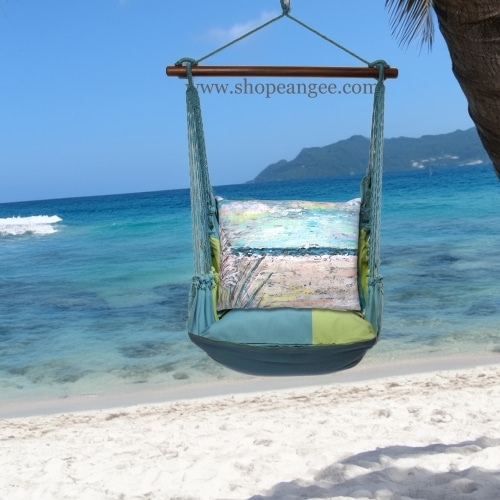 In an outdoor reading nook a multi colored outdoor swing crafted by the artisans of Magnolia Casual called the Swing Set 4 piece Meadow Mist Stripe w/ Coastal Landscape 1 is displayed featuring 100 percent weather resistant fabric, weather resistant polyester fabric, handcrafted, natural materials adding comfort and style to the space featuring with a stripe motif.