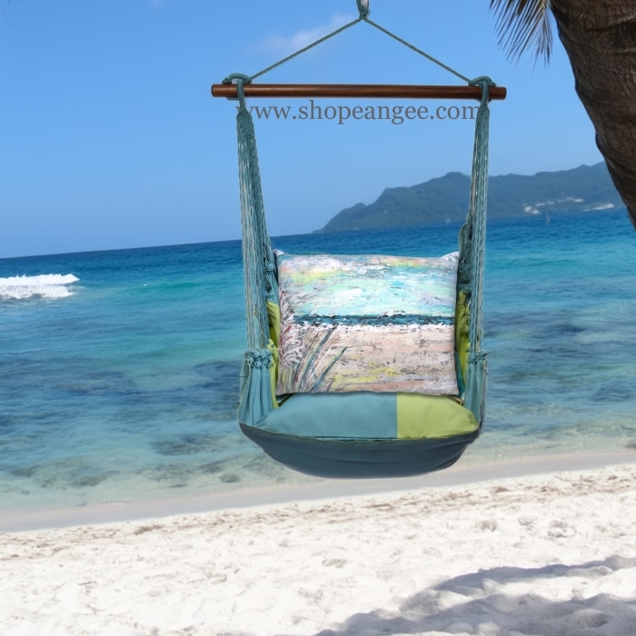 In an outdoor reading nook a multi colored outdoor swing crafted by the artisans of Magnolia Casual called the Swing Set 4 piece Meadow Mist Stripe w/ Coastal Landscape 1 is displayed featuring 100 percent weather resistant fabric, weather resistant polyester fabric, handcrafted, natural materials adding comfort and style to the space featuring with a stripe motif.