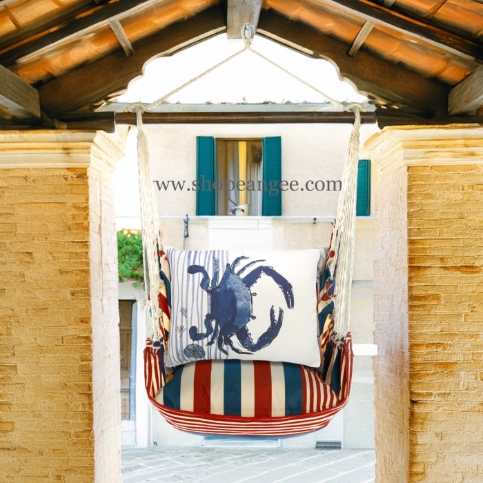 In a poolside chaise a multi colored outdoor swing crafted by the artisans of Magnolia Casual called the Swing Set 4 piece Stars & Stripes w/ Crab is displayed featuring 100 percent weather resistant fabric, weather resistant polyester fabric, handcrafted adding comfort and style to the space featuring with a stripes motif.
