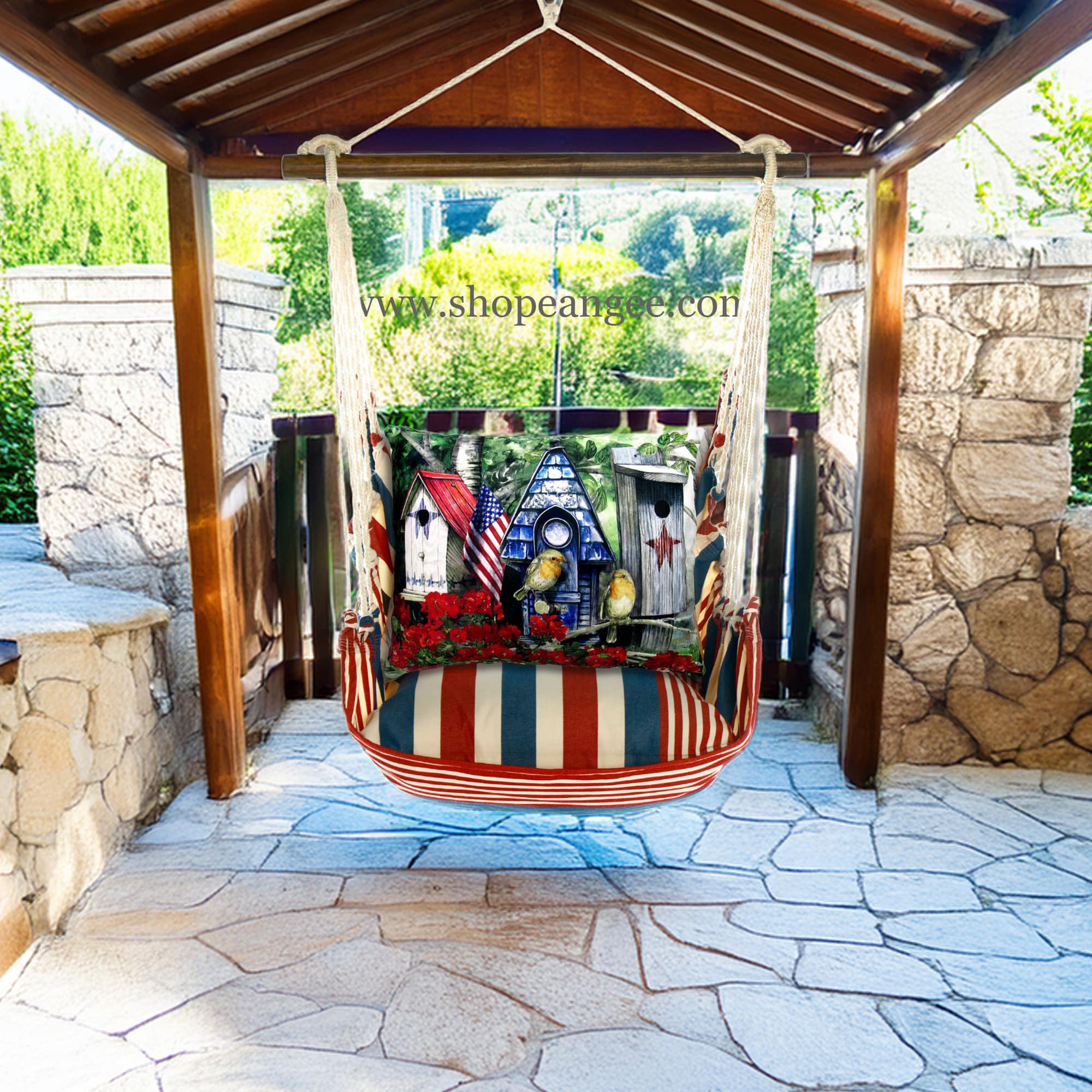 In a poolside chaise a multi colored outdoor swing crafted by the artisans of Magnolia Casual called the Swing Set 4 piece Stars & Stripes w/ Americana Birdhouses is displayed featuring 100 percent weather resistant fabric, weather resistant polyester fabric, handcrafted adding comfort and style to the space featuring with a stripes motif.
