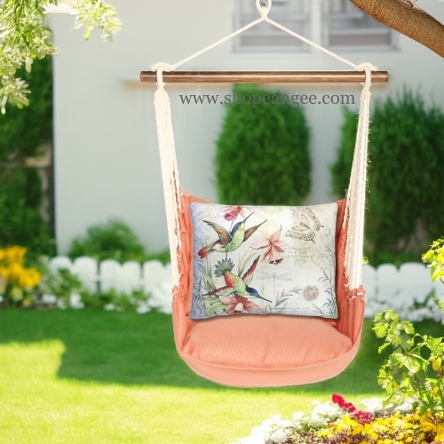 In a cozy garden seating area a multi colored outdoor swing crafted by the artisans of Magnolia Casual called the Swing Set 4 piece Living Coral w/ Hummingbirds is displayed featuring 100 percent weather resistant fabric, weather resistant polyester fabric, handcrafted adding comfort and style to the space featuring with a coral motif and shades of coral.