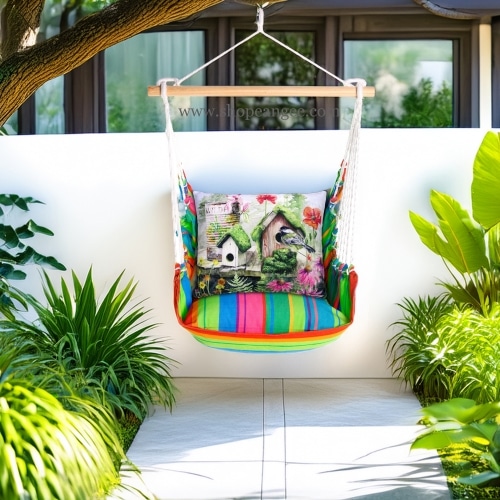 In a poolside chaise a multi colored outdoor swing crafted by the artisans of Magnolia Casual called the Swing Set 4 piece Le Jardin Nouveau w/ Garden Birdhouses is displayed featuring 100 percent weather resistant fabric, weather resistant polyester fabric, handcrafted adding comfort and style to the space.