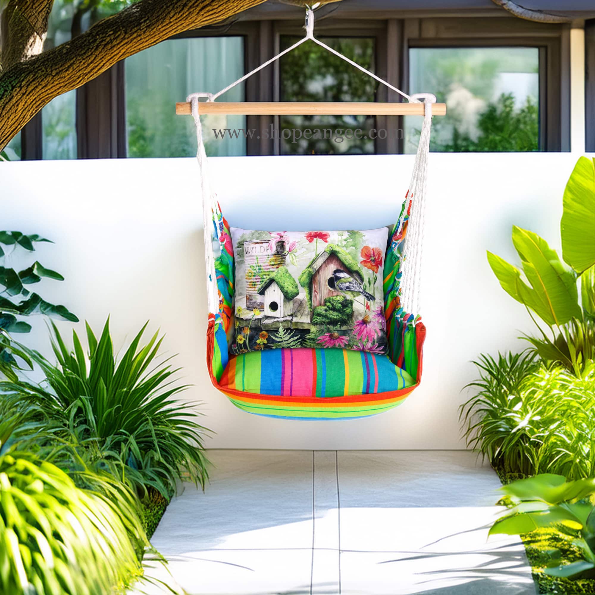 In a poolside chaise a multi colored outdoor swing crafted by the artisans of Magnolia Casual called the Swing Set 4 piece Le Jardin Nouveau w/ Garden Birdhouses is displayed featuring 100 percent weather resistant fabric, weather resistant polyester fabric, handcrafted adding comfort and style to the space.