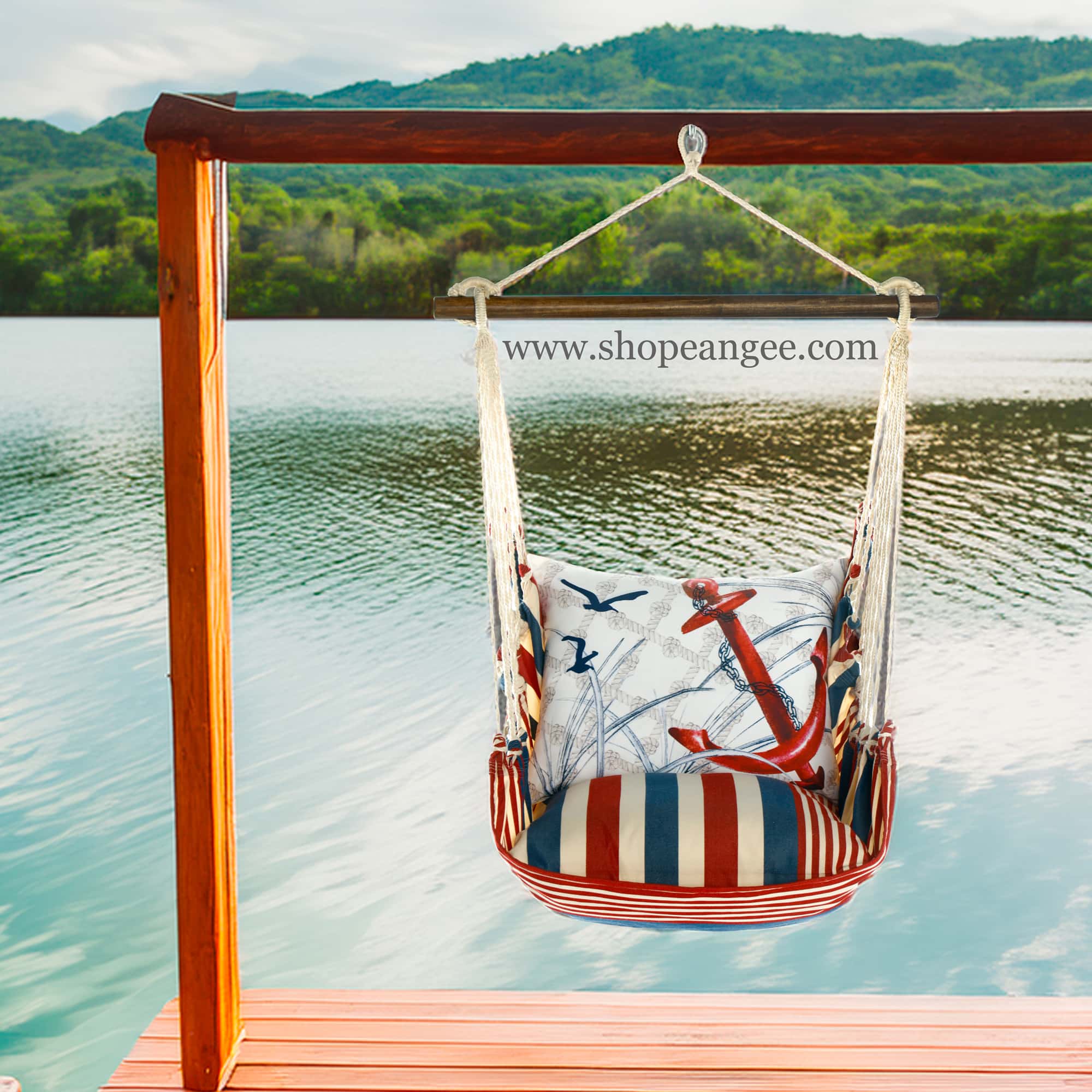 In a poolside chaise a red outdoor swing crafted by the artisans of Magnolia Casual called the Swing Set 4 piece Stars & Stripes w/ Red Anchor is displayed featuring 100 percent weather resistant fabric, weather resistant polyester fabric, handcrafted adding comfort and style to the space featuring with a stripes motif and shades of red.