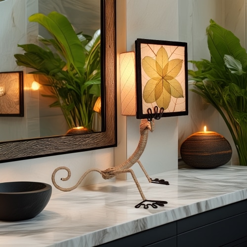 In a modern interior with earth tones, crafted by the artisans of Eangee Home Design, the Enlightened Gecko Table Lamp in green stands gracefully, featuring fossilized cocoa leaf shade, guyabano leaf shade, abaca rope accents, wrought iron frame, handcrafted, adding warmth and character to the space.