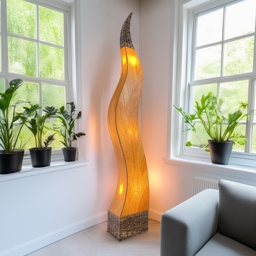 In a sun drenched entryway, crafted by the artisans of Eangee Home Design, the Flame Giant Lamp in orange stands gracefully, featuring fossilized cocoa leaf shade, abaca rope accents, fair trade, adding warmth and character to the space.