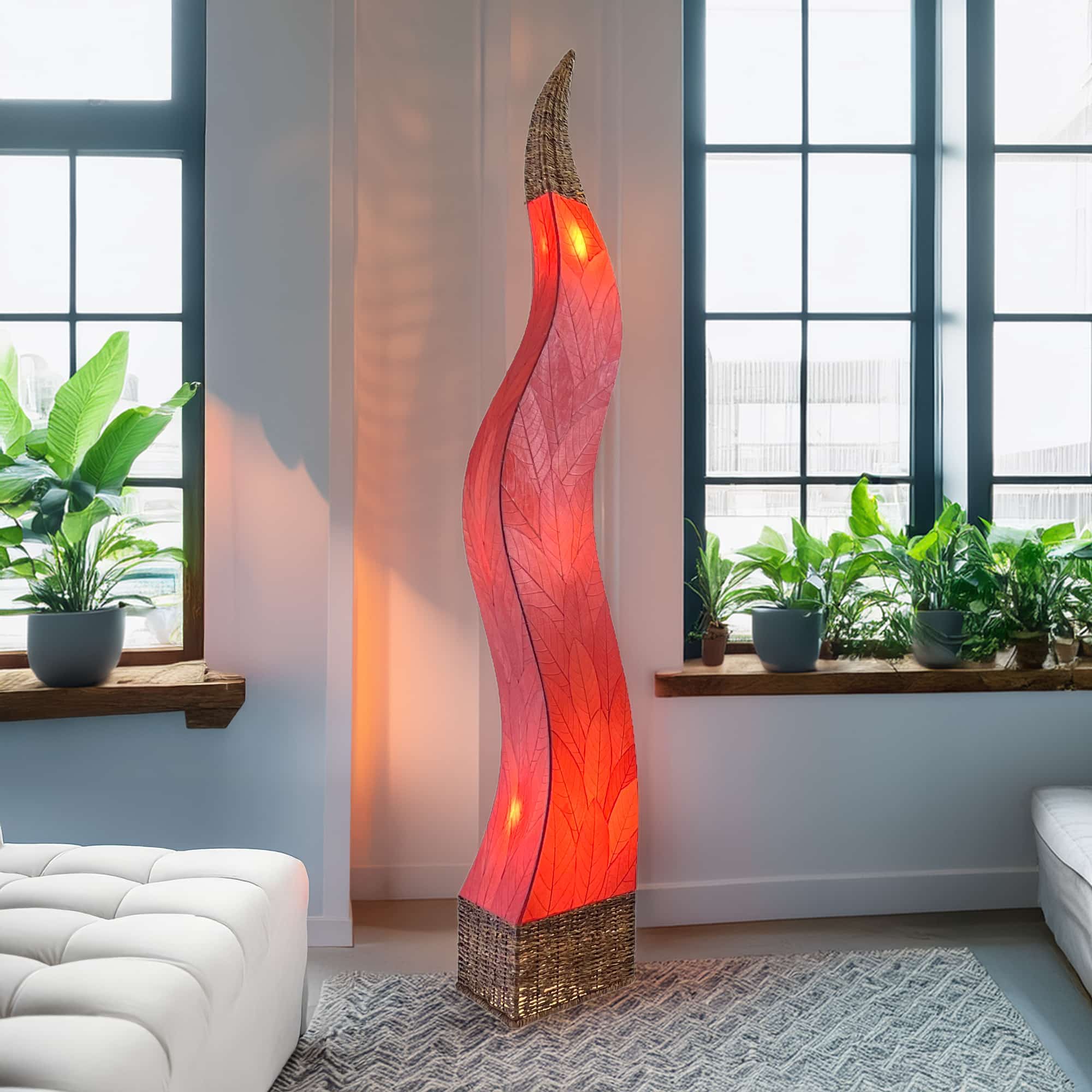 In a modern interior with earth tones, crafted by the artisans of Eangee Home Design, the Flame Giant Lamp in red stands gracefully, featuring fossilized cocoa leaf shade, abaca rope accents, fair trade, adding warmth and character to the space.