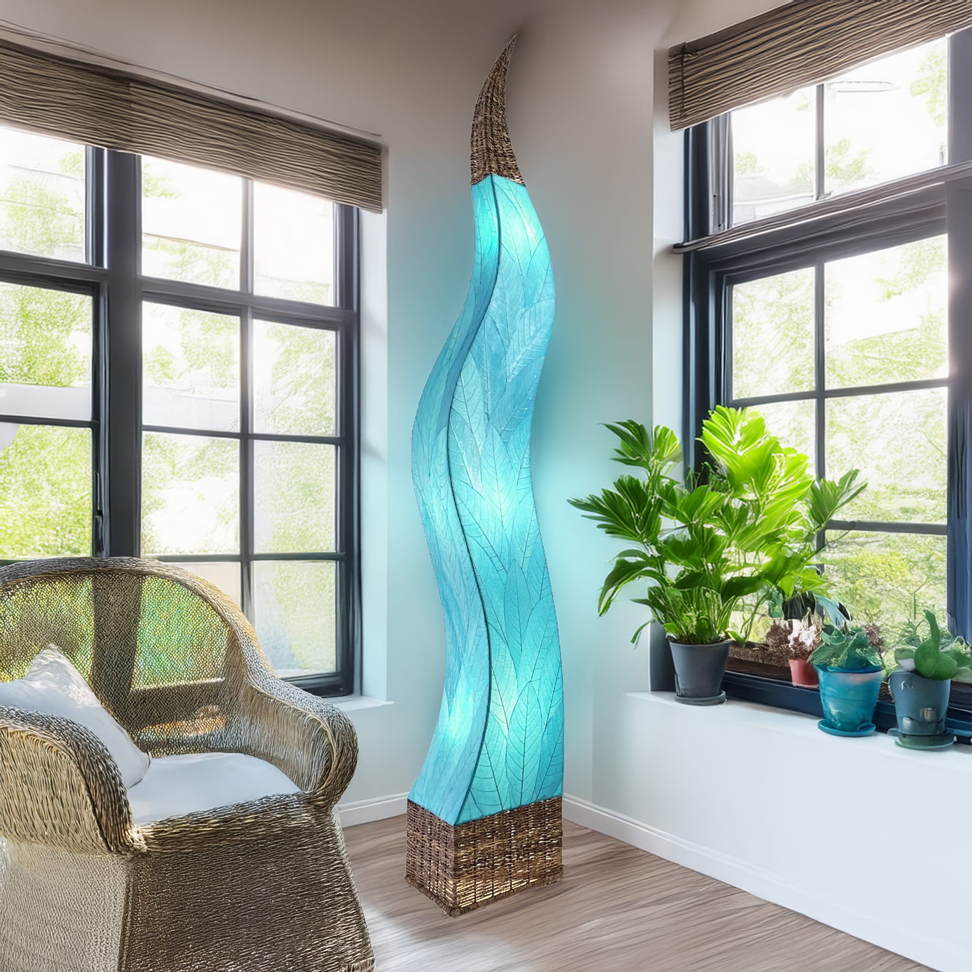 The Flame Giant crafted by the artisans of Eangee Home Design Lamp in sea blue finish by Eangee Home Design displayed against a white background highlights its fossilized cocoa leaf panels, abaca twine accents, and hand placed natural leaves, designed to the flame giant lamp is a celebration of humanity's oldest light: fire.